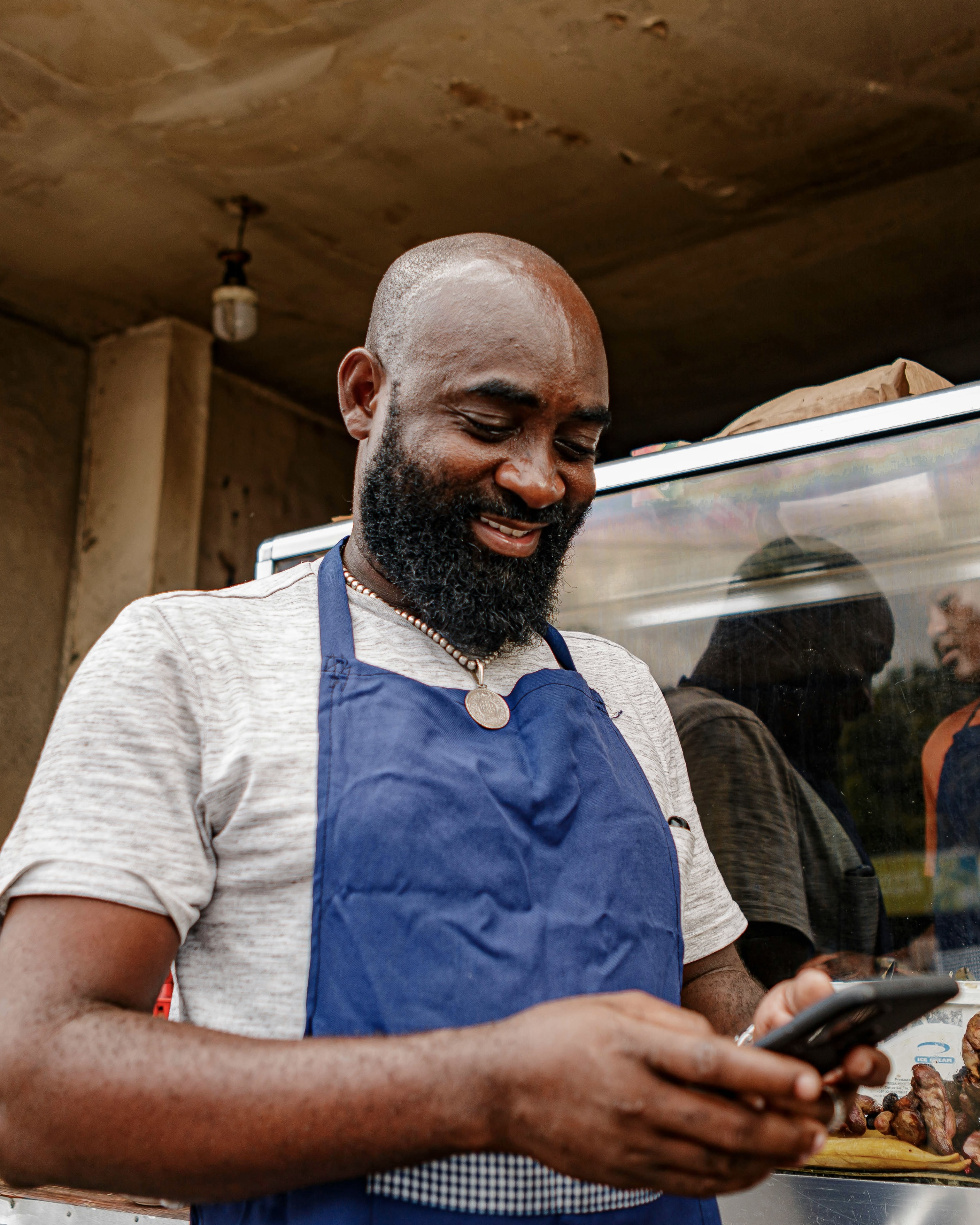 A contractor checking a new customer inquiry on his phone between jobs